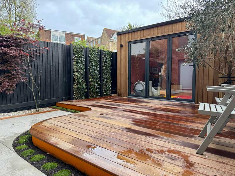 contemporary design garden room within a leafy green landscaped garden