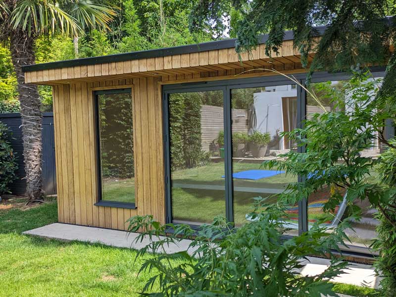 timber clad garden room from Aoba Landscapes in attractively landscaped garden