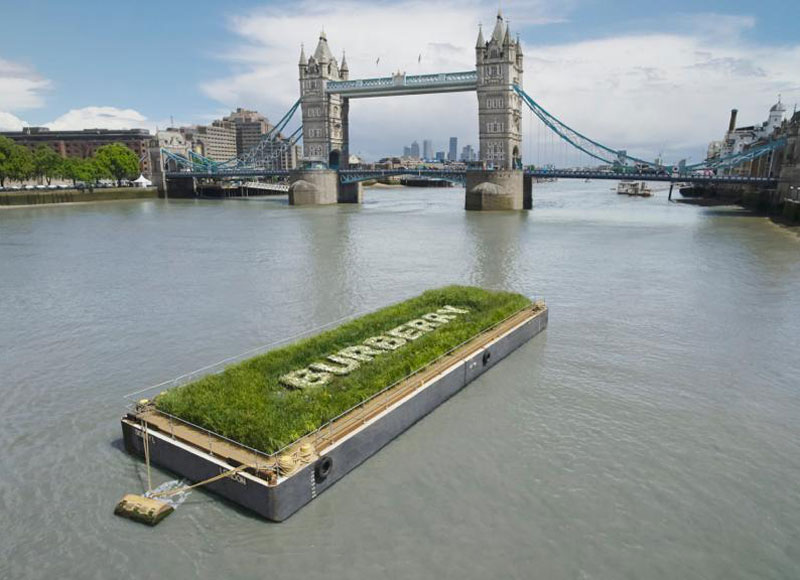 The Burberry floating meadow approaches Tower Bridge in London