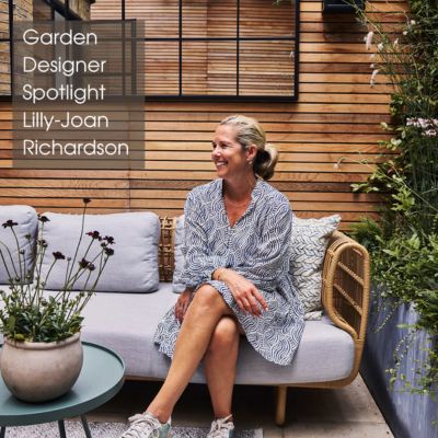 garden designer Lilly-Joan Richardson sitting in one of the outdoor spaces she has created