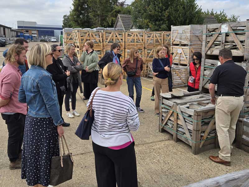 A group of garden designers examining landscaping materials at Arbour Landscape Solutions yard in Leighton Buzzard